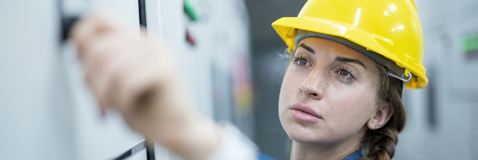 woman in hardhat at whiteboard  